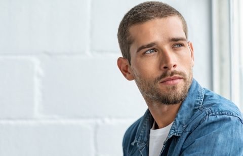 Young pensive man looking away